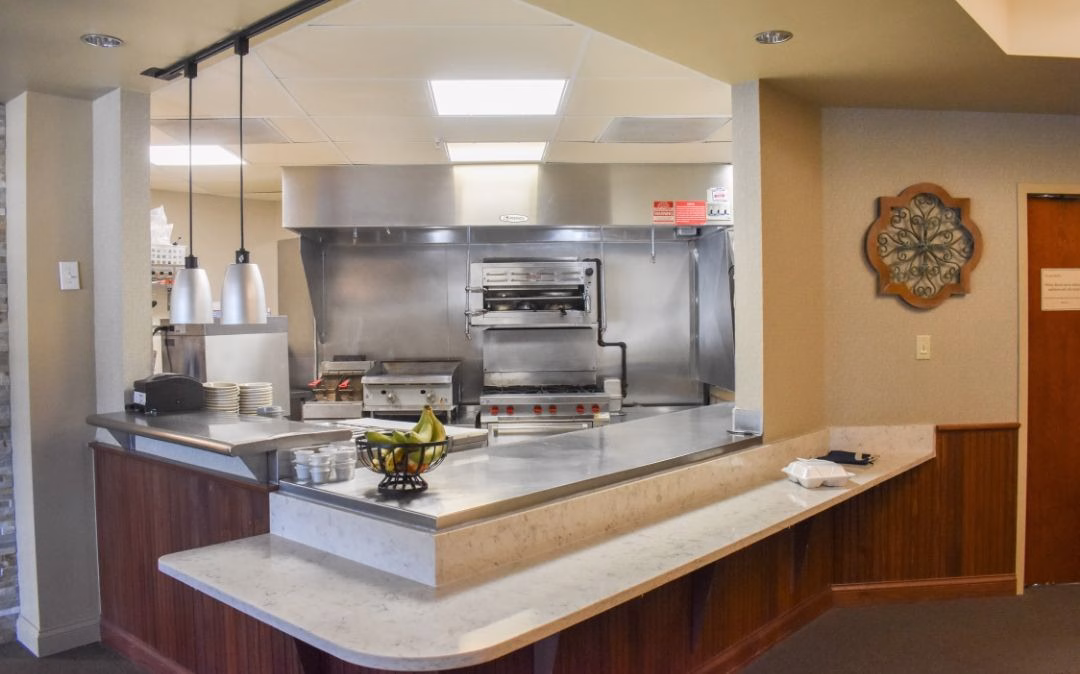 Open kitchen at the Grapevine café at Willow Brook Home, where freshly prepared meals support the daily dining experience for assisted living residents in Columbus, Ohio.